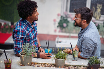 Two young man in friendly conversation