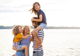 Wall Mural - Young family enjoying time at the beach 
