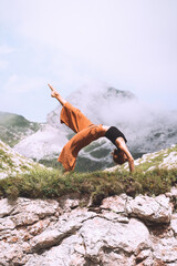 Wall Mural - Yoga on nature. Young woman is practicing yoga in mountains