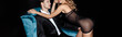 © LIGHTFIELD STUDIOS - Panoramic crop of handsome man in suit looking at sexy girlfriend while sitting in armchair isolated on black