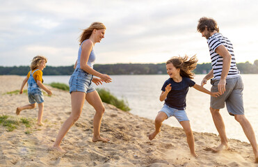 Wall Mural - Young family enjoying time at the beach 
