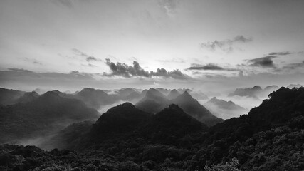 Wall Mural - Panoramic view of the CatBa National Park, Vietnam. View from the top of the jungle hills of karst cliffs at dawn. Black and white