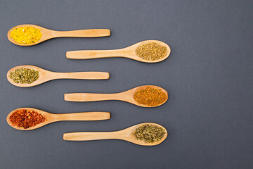 Various kind of spices for food in wooden zero waste spoons. Organic healthy concept 