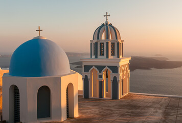 Church domes of a christian orthodox church during sunset. Aegean sea Santorini Greece