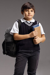 Canvas Print - Schoolboy with a backpack and books