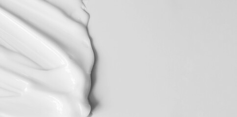 close-up cream moisturiser smear smudge wavy texture on white background with copy space horizontal 