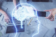 © peshkova - Double exposure of man and woman working together and human brain hologram drawing. Brainstorm concept. Computer background. Top View.