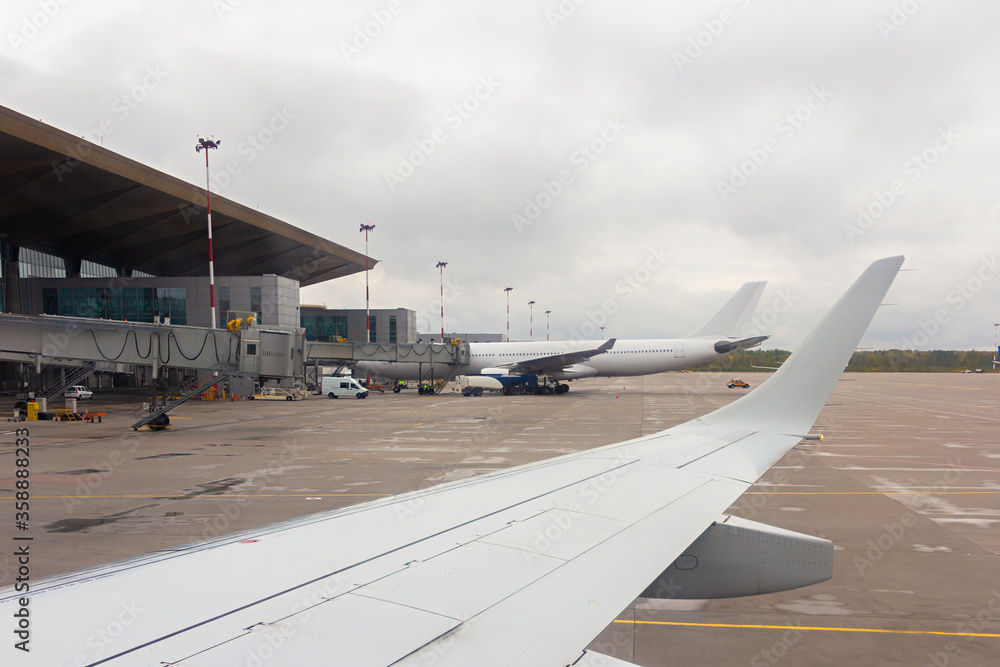 Airplane parked at the airport for preparation for a flight and loading ...