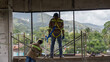 Construction workers repair window to a building. Workers in full person protective equipment, to do job as safe as possible.  