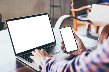 computer,cell phone mockup image.hand woman work using laptop texting mobile.blank screen with white background for advertising,contact business search information on desk in cafe.marketing,design