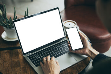 computer,cell phone mockup image.hand woman work using laptop texting mobile.blank screen with white background for advertising,contact business search information on desk in cafe.marketing,design