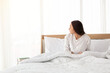 © Avirut S. - Young girl stretching in bed after wake up. Portrait of beautiful asian woman enjoying fresh soft bed linen mattress in bedroom. Woman Stretching in Her Bed. A Girl waking up in the Morning on bed.