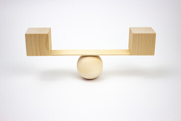 The concept of balance, choice, decision making, blackboard on a wooden ball, like balance isolated on a white background, balancing on a swing.