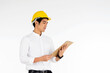 © NONTANUN - Portrait of handsome engineer wearing a yellow helmet at work and carrying a document on a white background