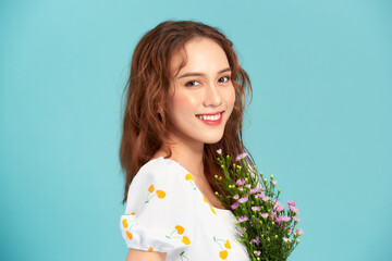 Wall Mural - daisy flowers field holds a young woman in blue