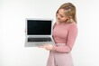 © Ivan Traimak - pensive stylish young woman holds laptop blank screen for website on white background