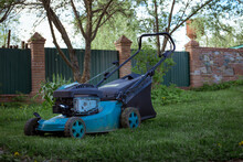 Lawnmower On The Background Of A Garden And Green Nature With Plants