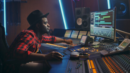 Poster - Stylish Audio Engineer Working in Music Recording Studio, Uses Mixing Board and Software to Create Modern Hit Song. Creative Black Artist Musician Working on Desk Control Surface to Produce New Song