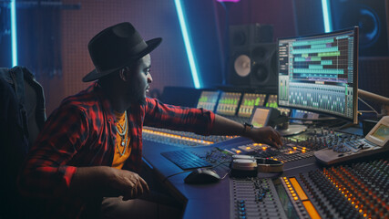 Poster - Stylish Audio Engineer / Producer Working in Music Recording Studio, Uses Mixing Board and Software to Create Hit Song. Creative Black Artist Musician Using Control Desk to Produce New Track.