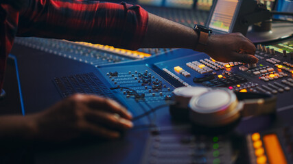 Poster - Close-up Shot of Audio Engineer, Music Creator, Musician, Artist Works in the Music Record Studio, Uses Surface Control Desk EQ Mixer. Buttons, Faders, Sliders to Broadcast, Record, Play Hit Song.