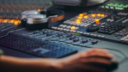 Poster - Close Up Shot of Hands of Audio Engineer and Producer Working in Music Recording Studio, Uses Mixing Board Create Modern Song.