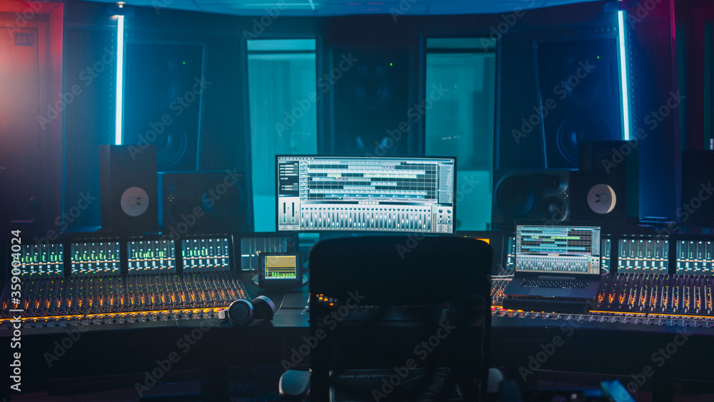 Shot of a Modern Music Record Studio Control Desk with Computer Screen show User Interface of DAW Software with Song Playing. Equalizer, Mixer and other Professional Equipment. - obrazy, fototapety, plakaty 