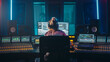 Artist, Musician, Audio Engineer, Producer in Music Record Studio, Uses Control Desk with Computer Screen showing Software UI with Song Playing. Dances. Back View
