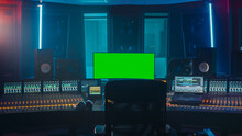 Modern Music Record Studio Control Desk With Green Screen Chroma Key Computer, Equalizer, Mixer And Other Professional Equipment. Switchers, Buttons, Faders, Sliders. Record, Play Songs.