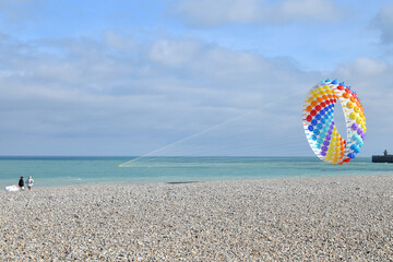 Multicolored air kite in the sky in Atlantic ocean