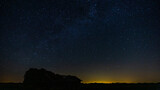 Fototapeta Kosmos - Starry filled sky with an abandoned barn in the foreground