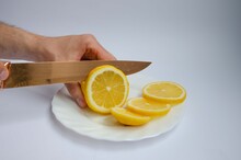 Sliced Juicy Lemon And A Knife, Slices Of Lemon Close Up.