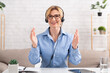 Work from home and video call. Woman with headset, gesticulation to camera