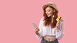 © Prostock-studio - Girl Holding Phone And Credit Card Standing On Pink Background
