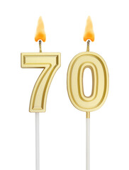 Burning golden birthday candles isolated on white background, number 70