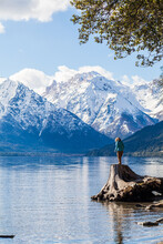 A Young Woman Enjoying Some Superb Views Over A Lake And Some Mountains In Patagonia Near Bariloche In Argentina.