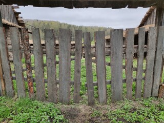 Fence from the boards. The texture of the old boards. Wooden elements of the fence.