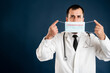 © Cipri Suciu  - Male doctor with stethoscope in medical uniform showing protective mask