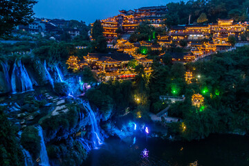 Wall Mural - Evening view of Furong Zhen town and waterfall, Hunan province, China