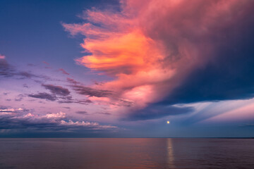 Wall Mural - Moon over Sea Horizon with Golden Sunset Clouds