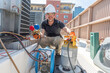 © spatesphoto - Happy HVAC technician recovering refrigerant