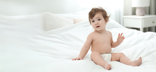 Poster - Cute little baby in diaper on bed, space for text. Banner design