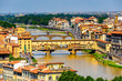 It's Ponte Vecchio (Old Bridge), a Medieval stone closed-spandrel segmental arch bridge over the Arno River, in Florence, Italy. View from the Michelangelo Square