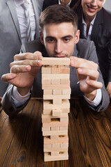 Poster - Business people building wood tower