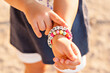 DIY bracelet for children from square, round, colored beads with the words 