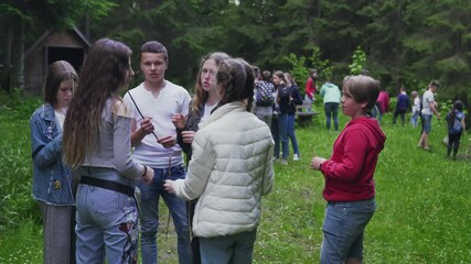 Wall Mural - Camp friends talking near campfire.