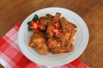 Photos of chicken food cooked spicy and served on a plate