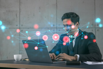 Businessman in office working with laptop, abstract technology hologram, typing computer. Double exposure.