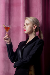 Poster - Beautiful blonde girl with cocktail on suede background