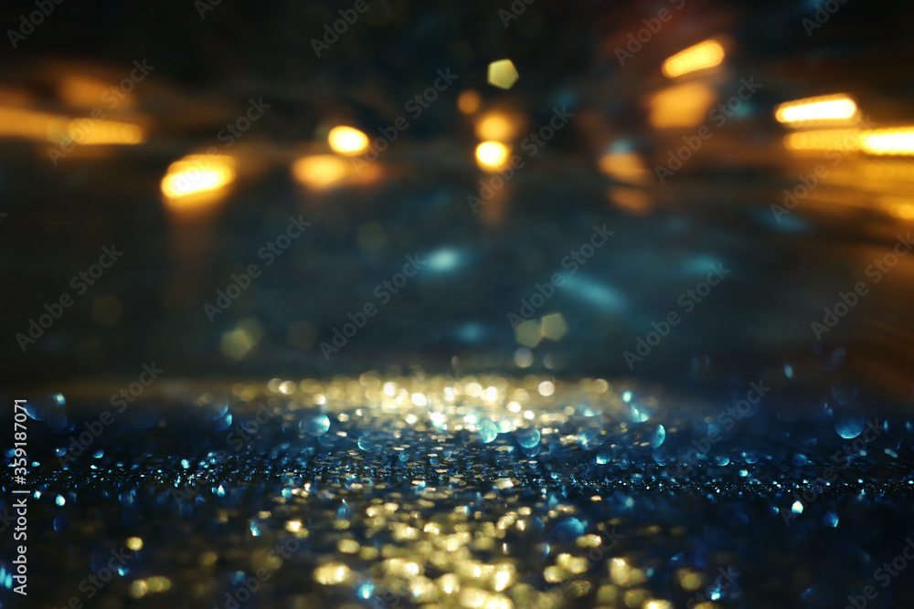 background of abstract glitter lights. gold, blue and black. de focused - obrazy, fototapety, plakaty 