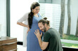 © narong - Man sit and listen baby sound from his pregnancy wife belly and he look happy to hear baby sound. Concept of good relationship of family member support good quality of life in new normal lifestyle.
